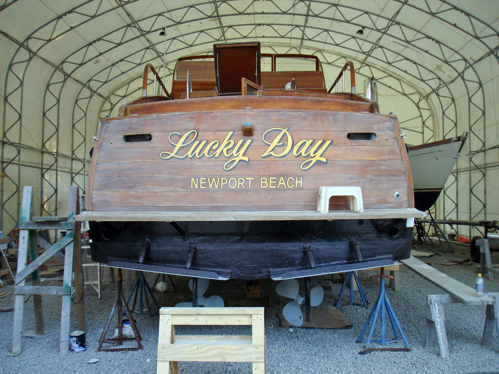 WOODEN MOTOR BOAT INTHE INDOOR FACILITY FOR SERVICE